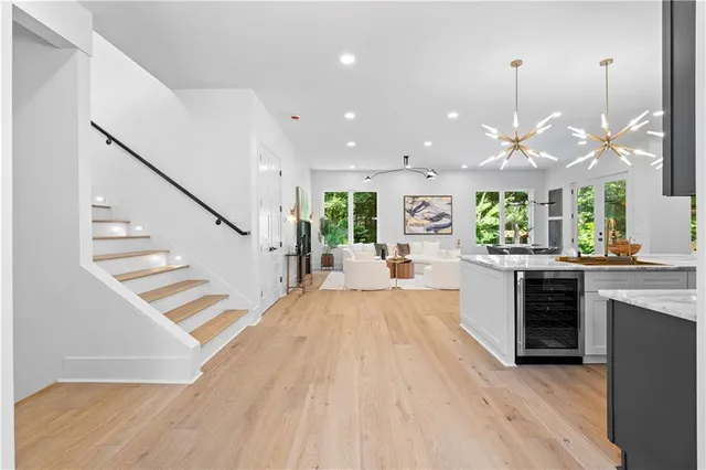 a kitchen with stainless steel appliances a table chairs and chandelier