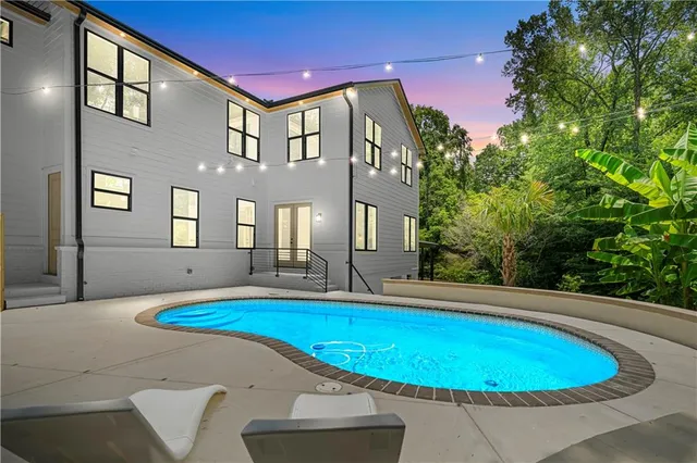 a view of a dining room with furniture wooden floor and chandelier