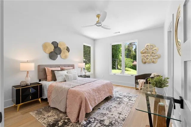 a front view of a house with a garden and trees