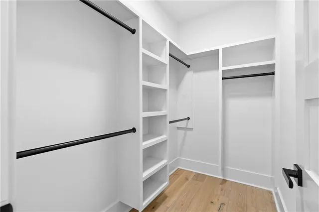 an aerial view of residential houses with outdoor space and parking