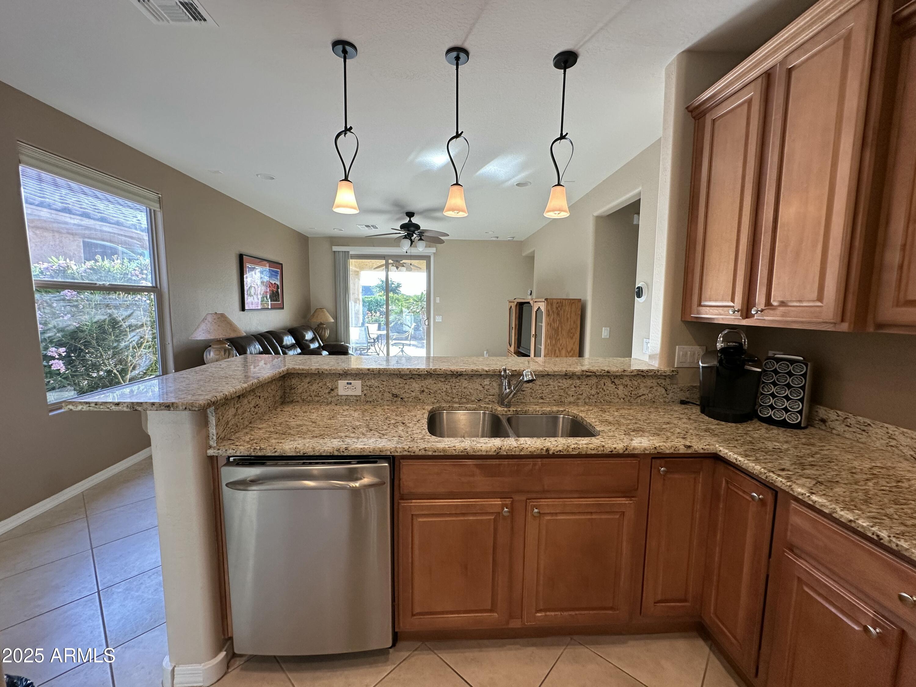 21280 North 262nd Drive Buckeye, AZ 85396 - Photo 14 of 51 a kitchen with granite countertop a sink a counter space appliances and cabinets