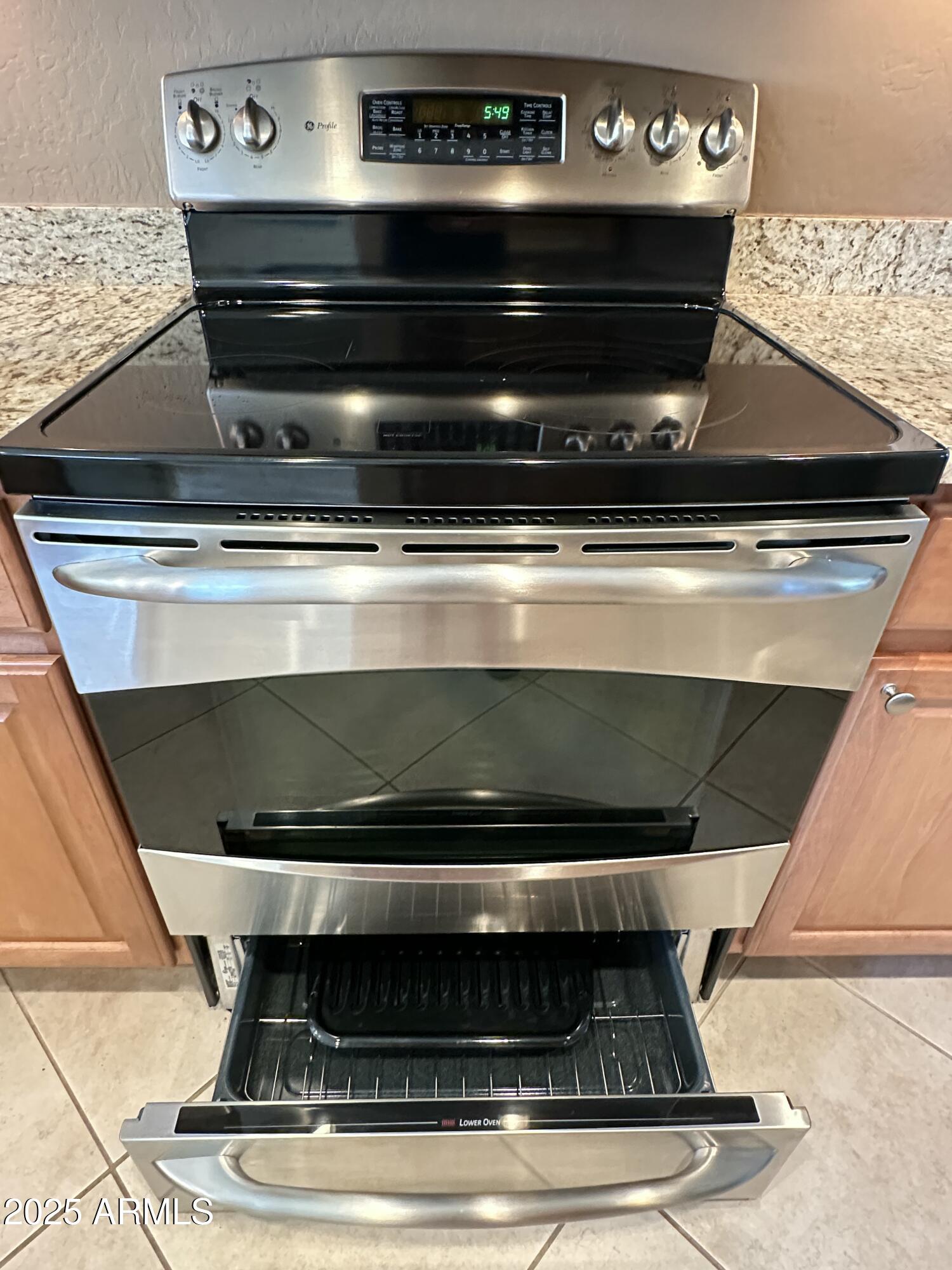 21280 North 262nd Drive Buckeye, AZ 85396 - Photo 15 of 51 a stove top oven sitting inside of a kitchen