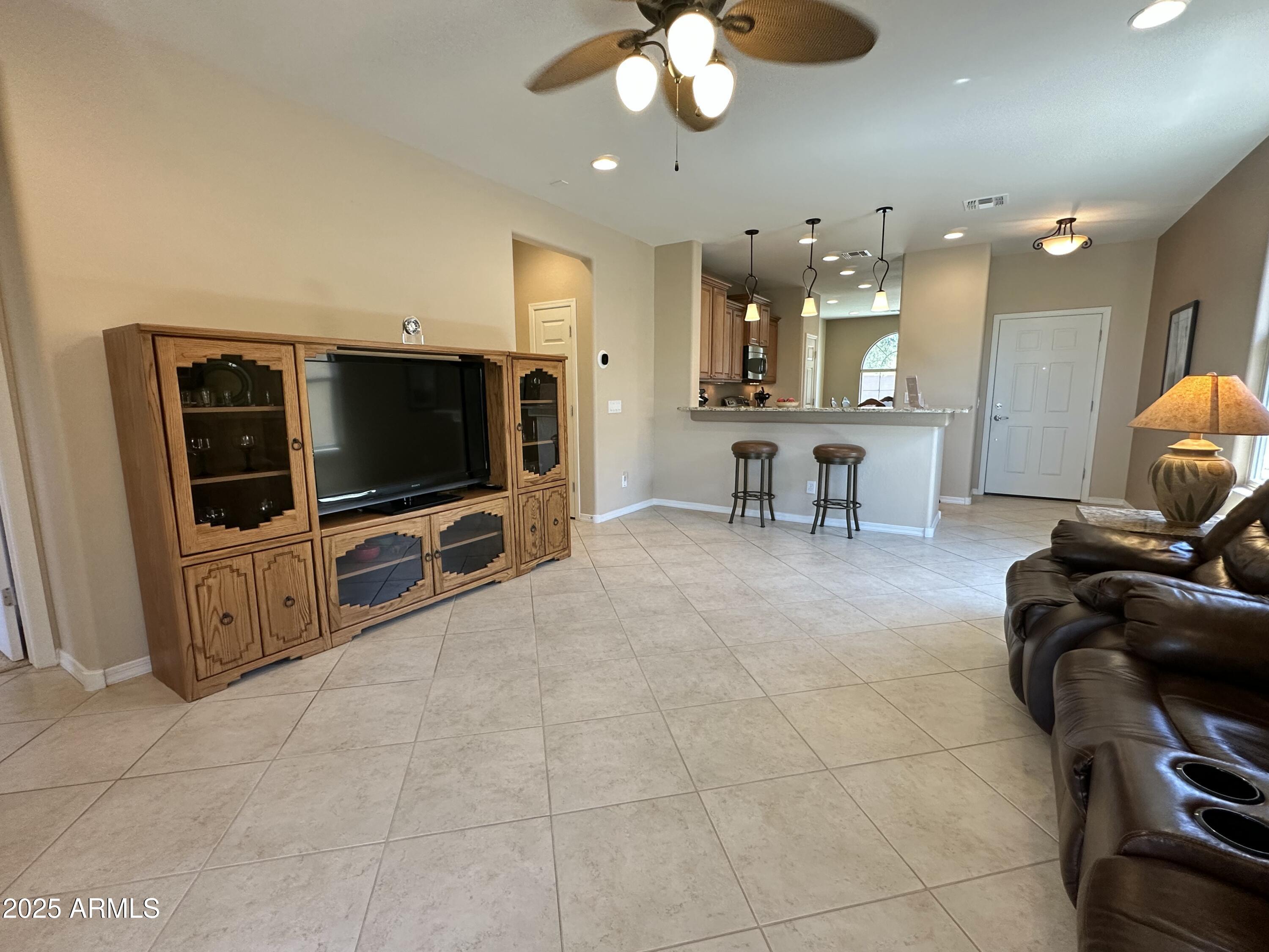 21280 North 262nd Drive Buckeye, AZ 85396 - Photo 18 of 51 a living room with furniture and a flat screen tv