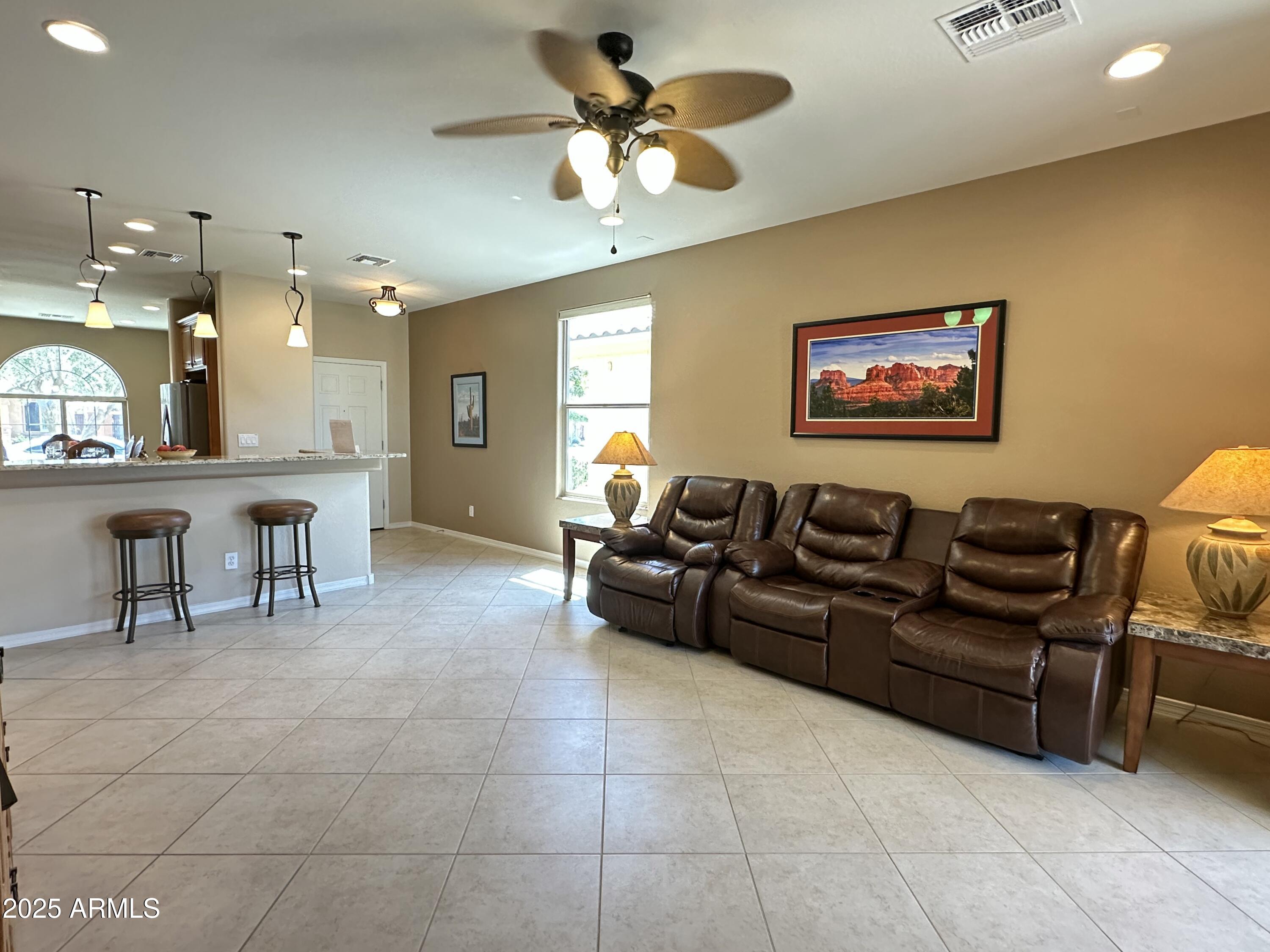 21280 North 262nd Drive Buckeye, AZ 85396 - Photo 19 of 51 a living room with furniture and a chandelier