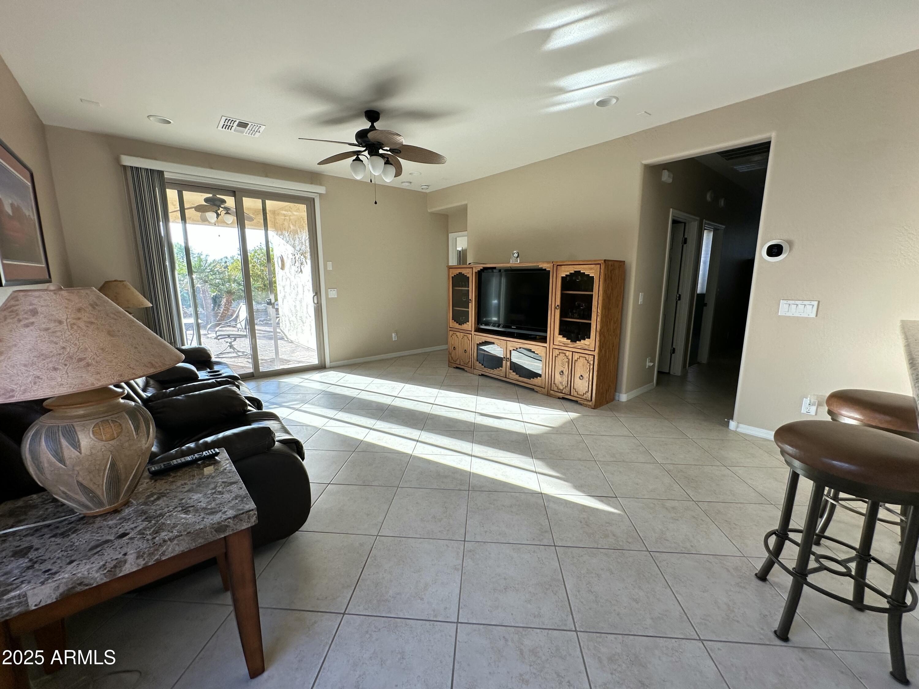 21280 North 262nd Drive Buckeye, AZ 85396 - Photo 21 of 51 a living room with furniture and a flat screen tv