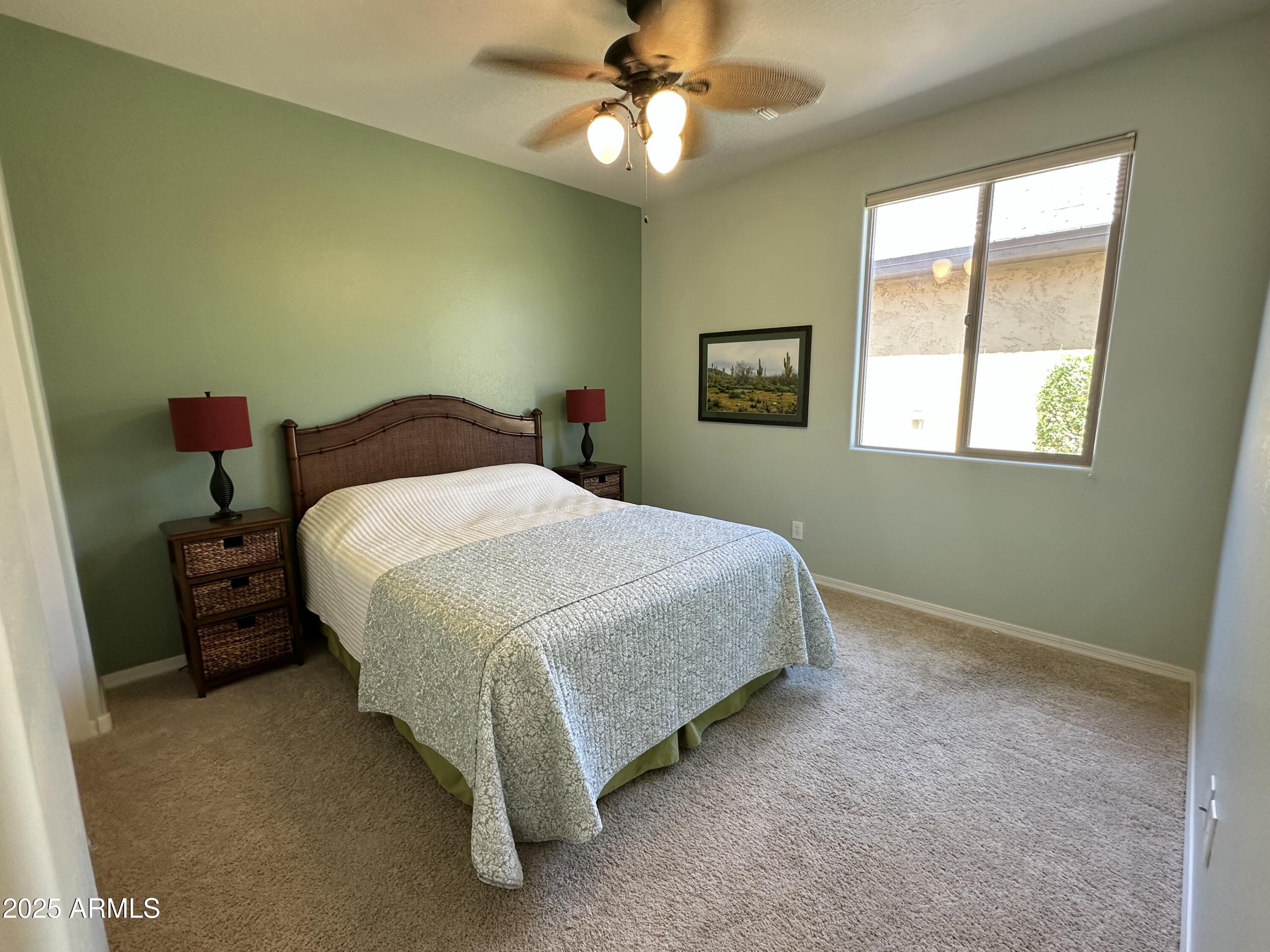 21280 North 262nd Drive Buckeye, AZ 85396 - Photo 26 of 51 a bedroom with a bed and a chandelier