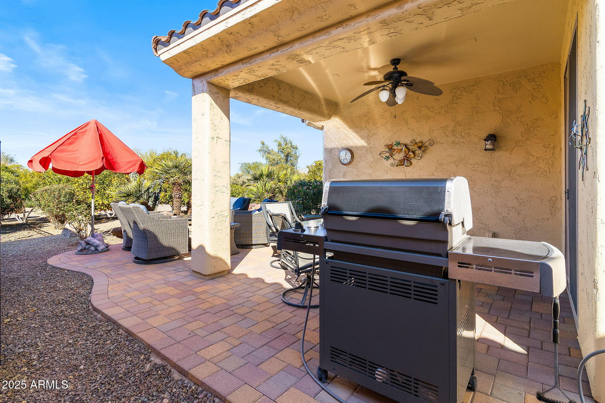 21280 North 262nd Drive Buckeye, AZ 85396 - Photo 34 of 51 a living room with furniture a flat screen tv and floor to ceiling window
