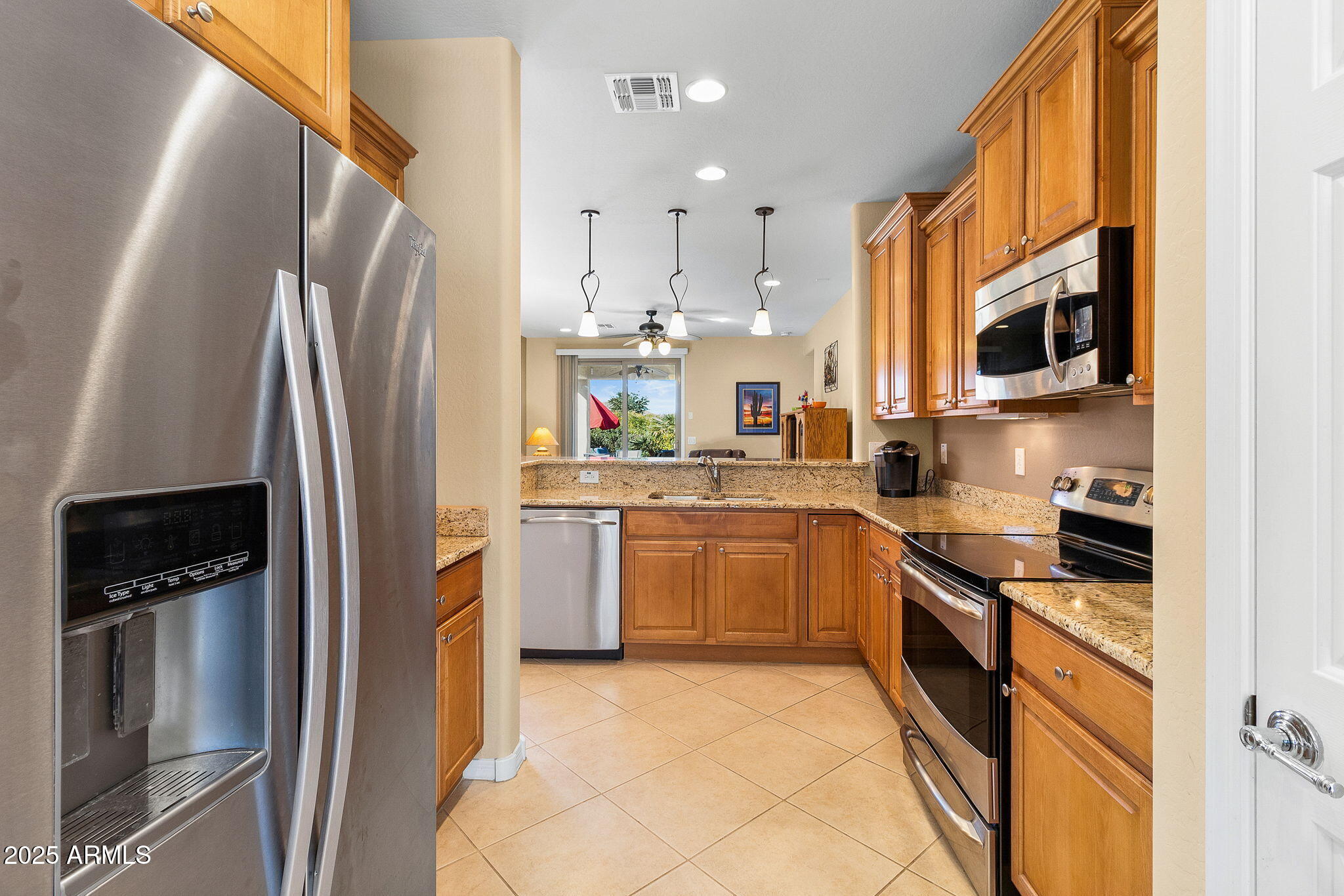 21280 North 262nd Drive Buckeye, AZ 85396 - Photo 10 of 51 a kitchen with stainless steel appliances granite countertop a refrigerator sink and stove