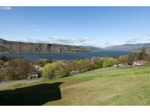 a view of a big yard with an outdoor seating