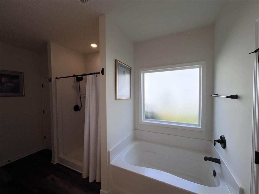245 S Ridge Senoia, GA 30276 - Photo 18 of 25 a bathroom with a bathtub and a shower
