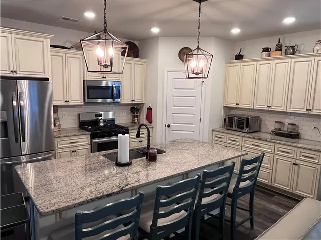 a kitchen with refrigerator a microwave a stove and refrigerator
