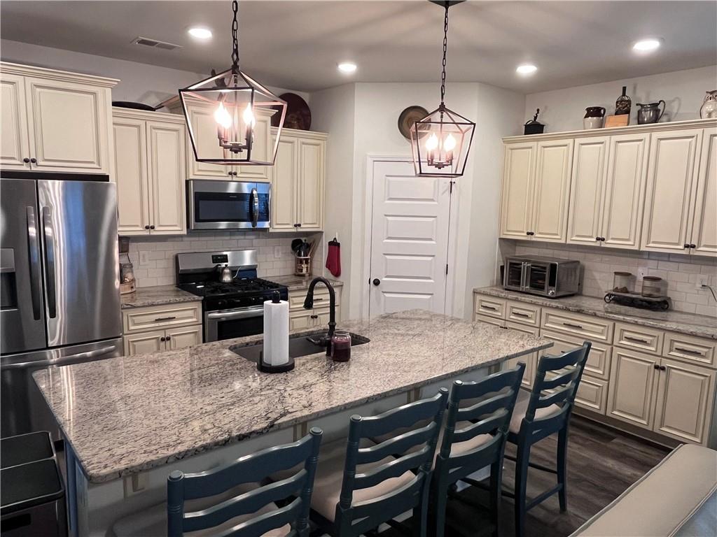 245 S Ridge Senoia, GA 30276 - Photo 6 of 25 a kitchen with refrigerator a microwave a stove and refrigerator