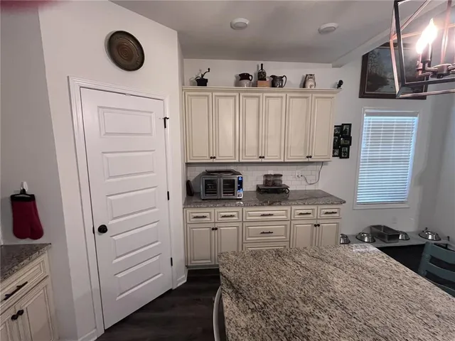 a kitchen with a sink cabinets and appliances