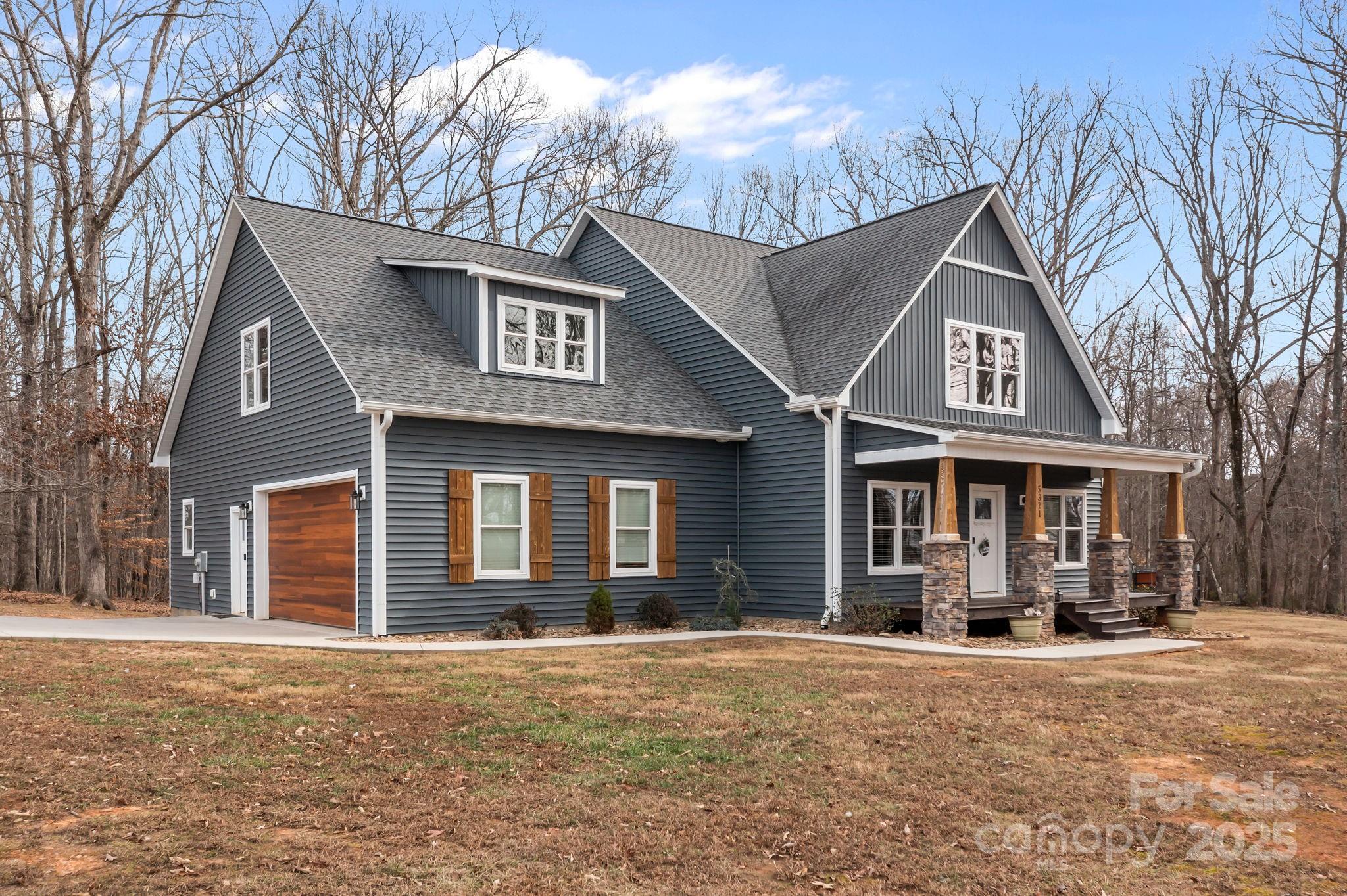5321 Vesuvius Furnace Road Iron Station, NC 28080 - Photo 1 of 48 a front view of a house with a yard and garage