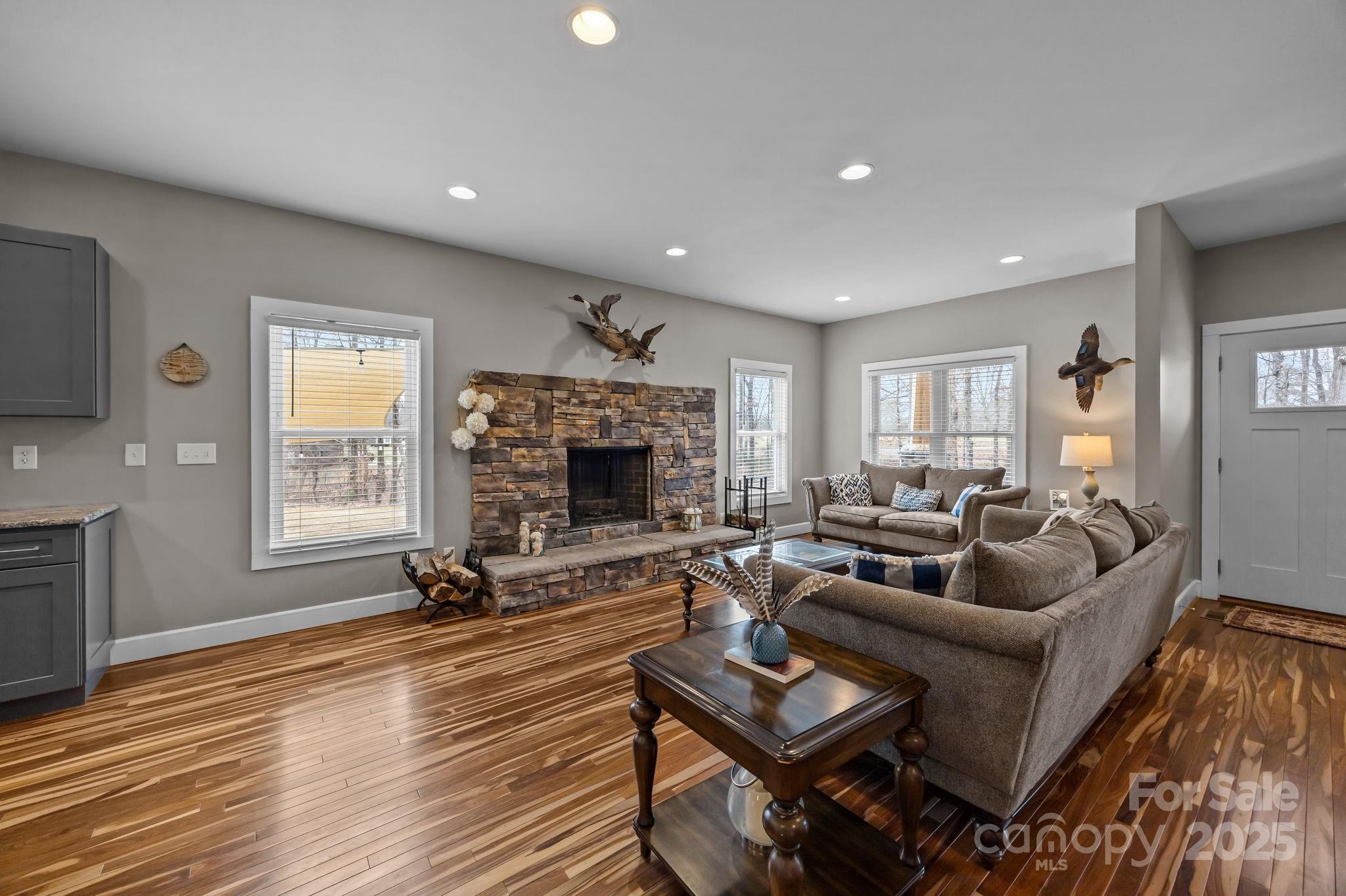 5321 Vesuvius Furnace Road Iron Station, NC 28080 - Photo 11 of 48 a living room with furniture a fireplace a flat screen tv and wooden floor