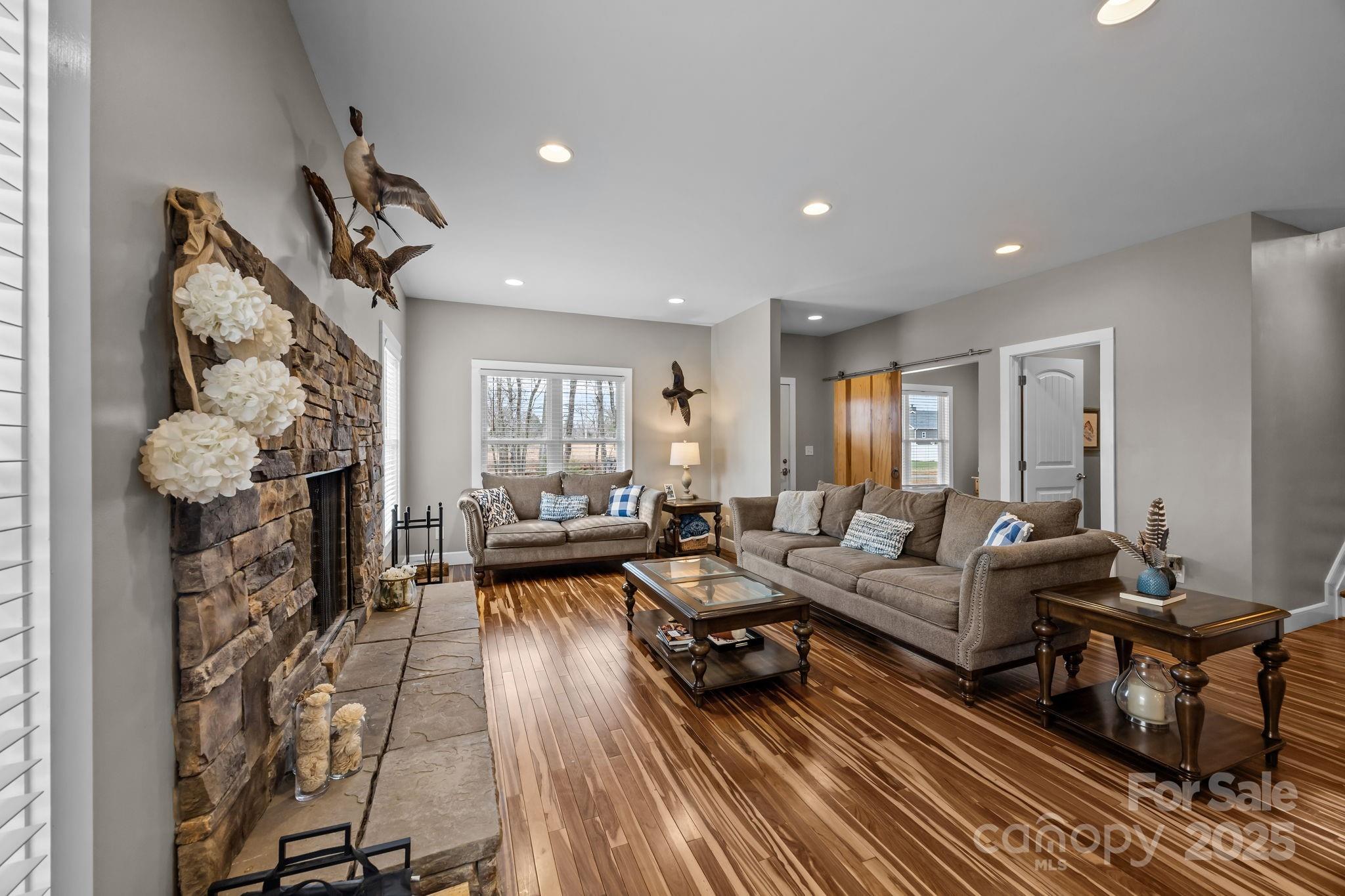 5321 Vesuvius Furnace Road Iron Station, NC 28080 - Photo 12 of 48 a living room with fireplace furniture and a wooden floor