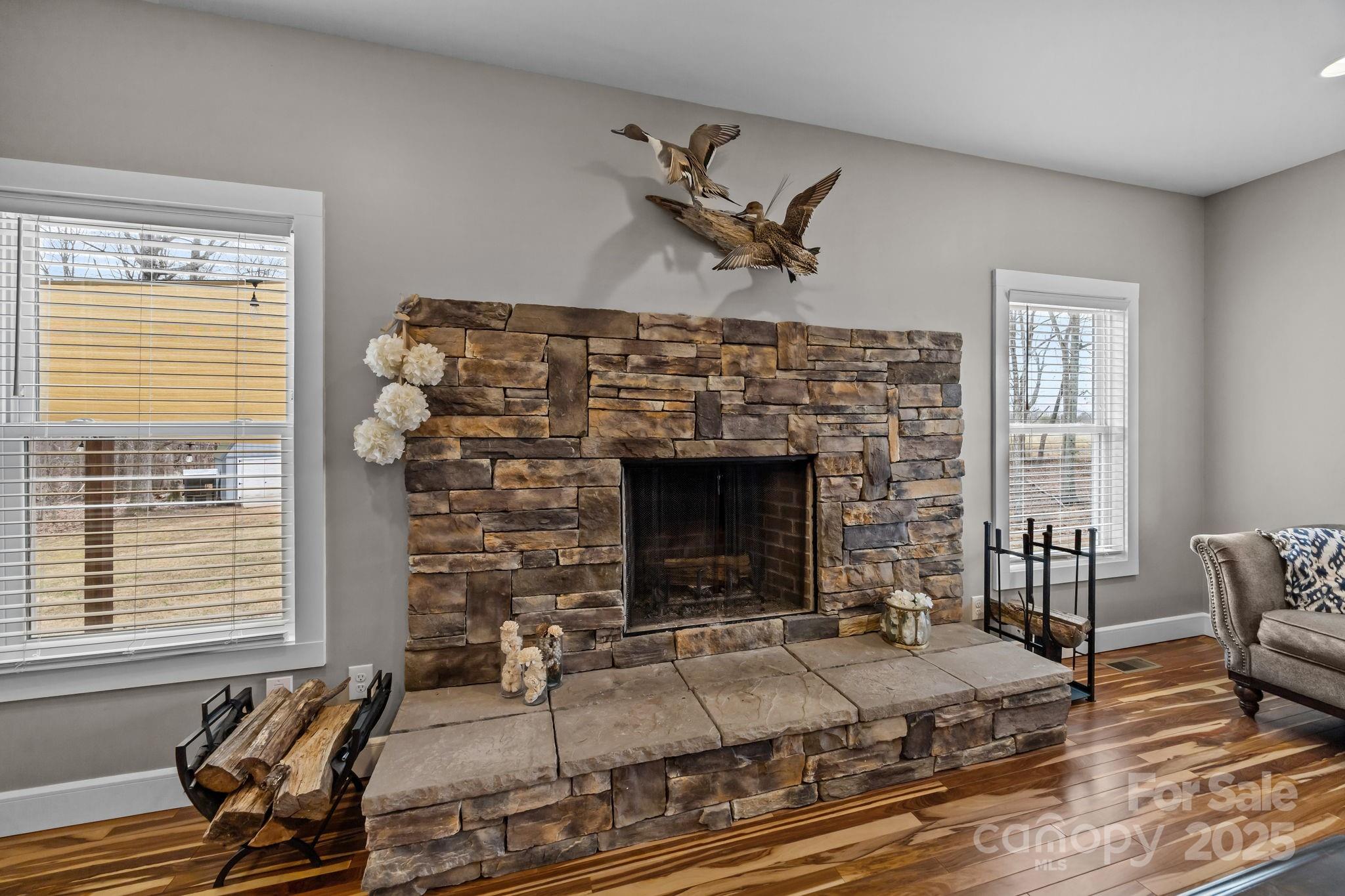 5321 Vesuvius Furnace Road Iron Station, NC 28080 - Photo 13 of 48 a living room with furniture a fireplace and wooden floor