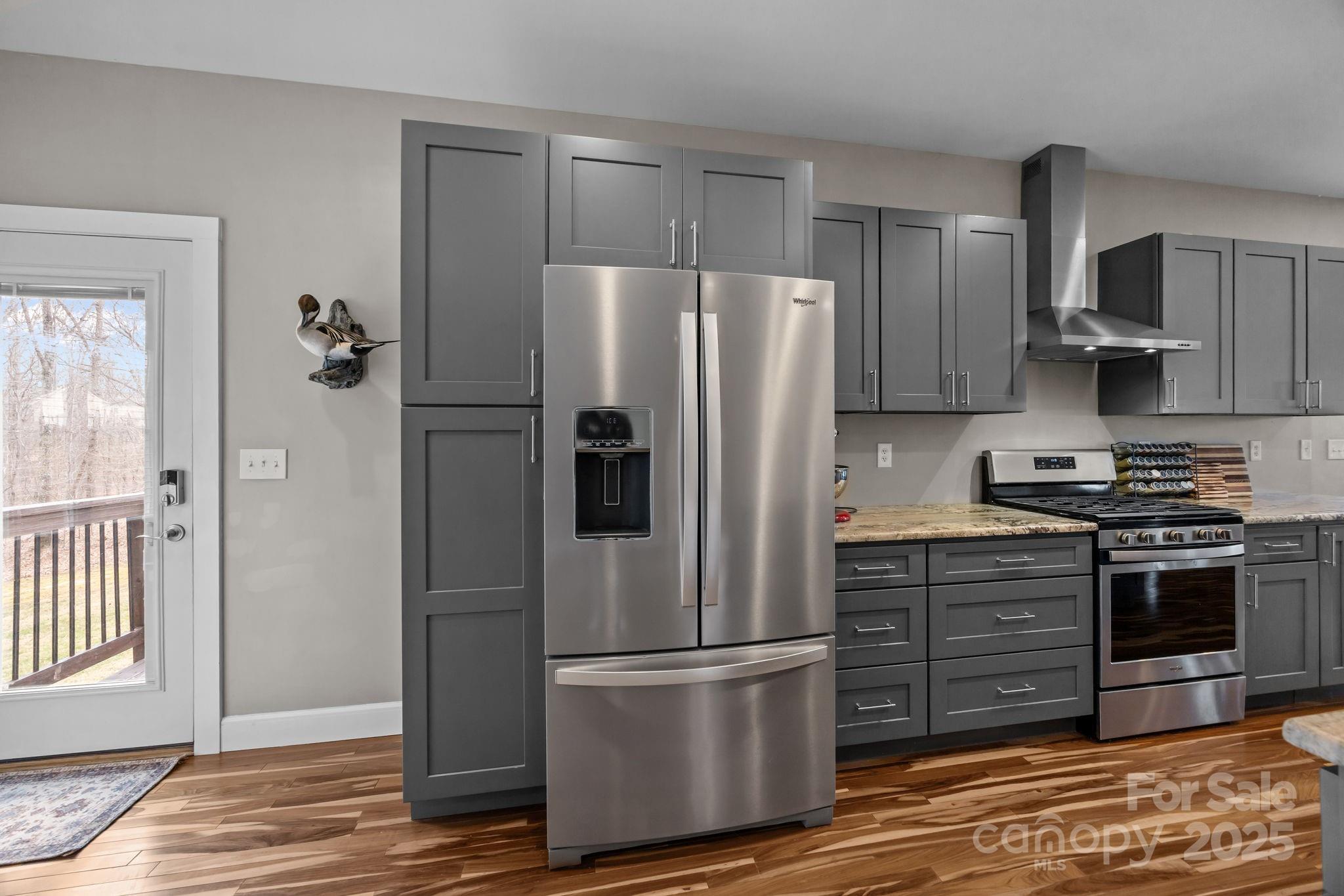 5321 Vesuvius Furnace Road Iron Station, NC 28080 - Photo 18 of 48 a kitchen with stainless steel appliances granite countertop a refrigerator stove and wooden cabinets