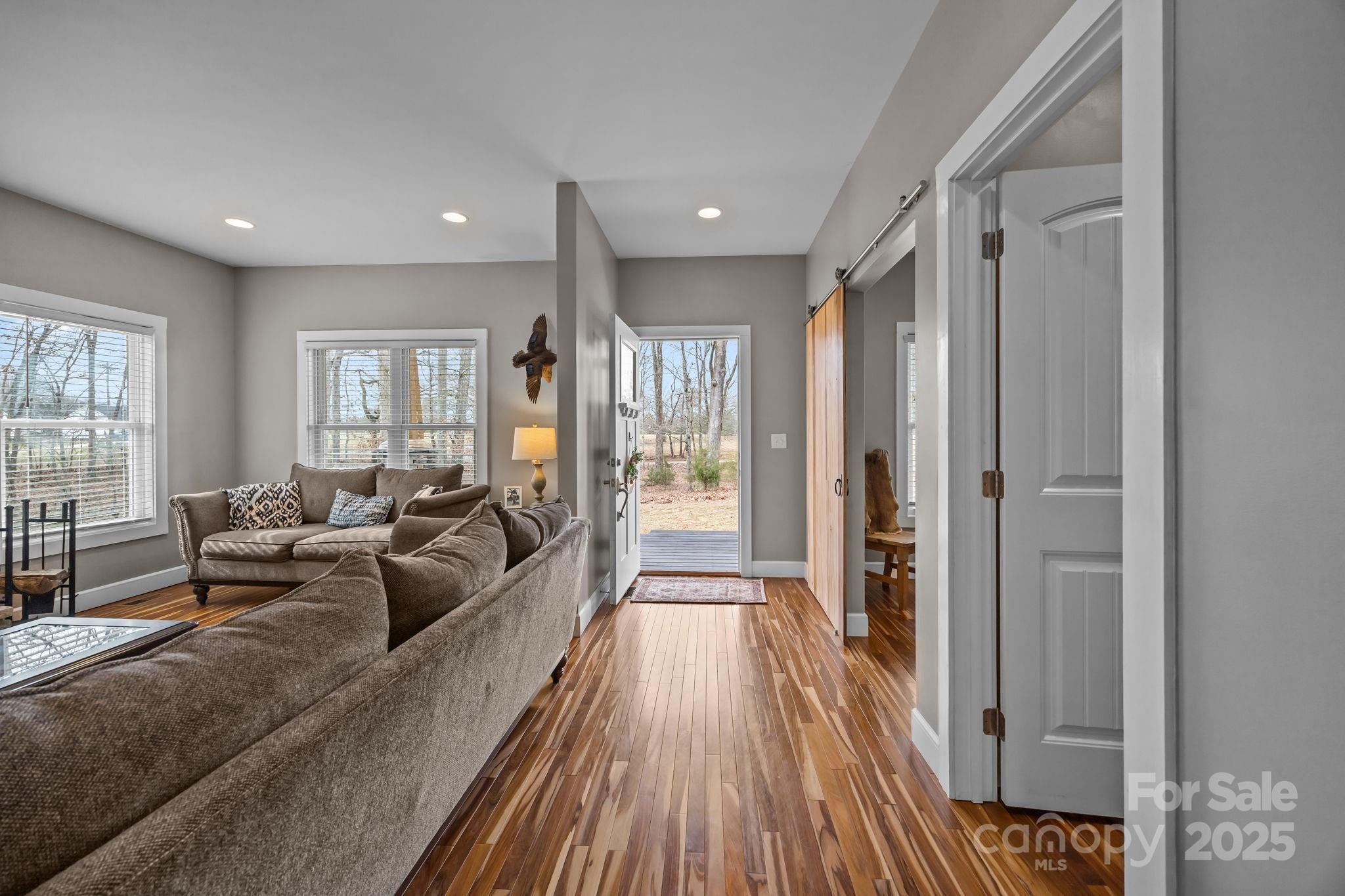 5321 Vesuvius Furnace Road Iron Station, NC 28080 - Photo 22 of 48 a living room with furniture and a wooden floor