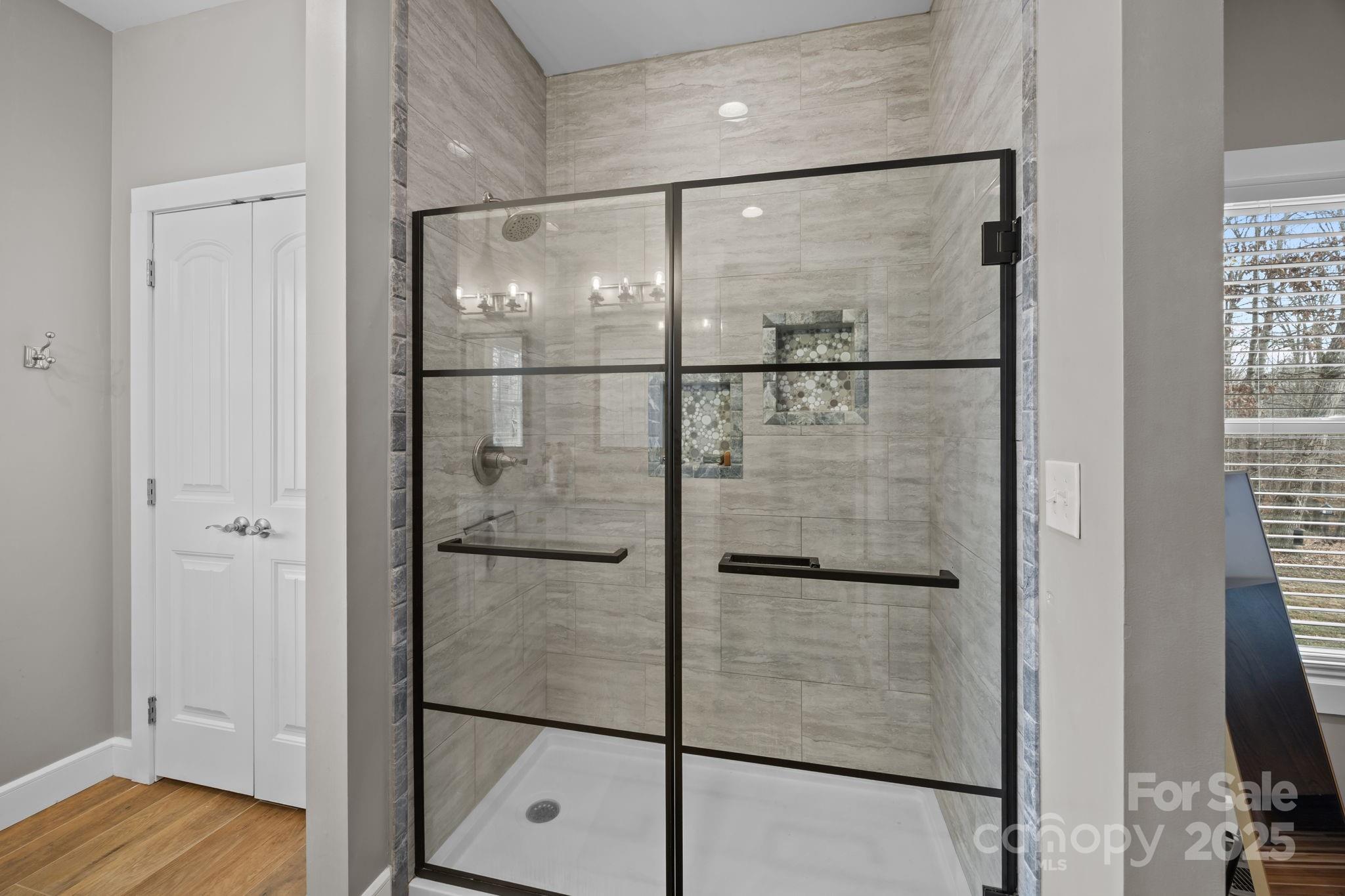 5321 Vesuvius Furnace Road Iron Station, NC 28080 - Photo 30 of 48 a bathroom with a glass shower door