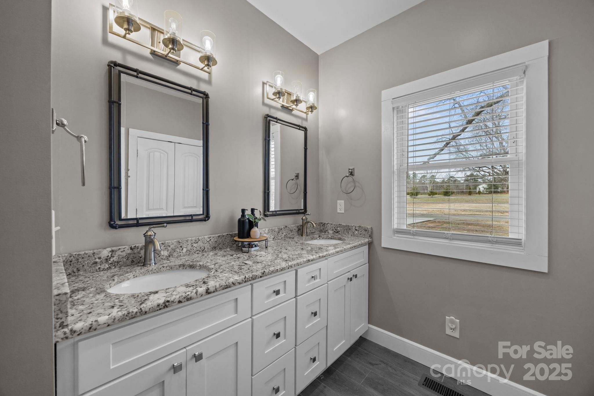 5321 Vesuvius Furnace Road Iron Station, NC 28080 - Photo 31 of 48 a bathroom with a granite countertop sink mirror and window
