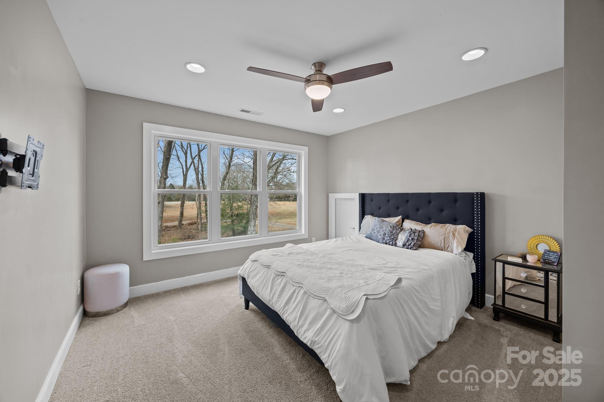 5321 Vesuvius Furnace Road Iron Station, NC 28080 - Photo 33 of 48 a bedroom with a bed and a large window