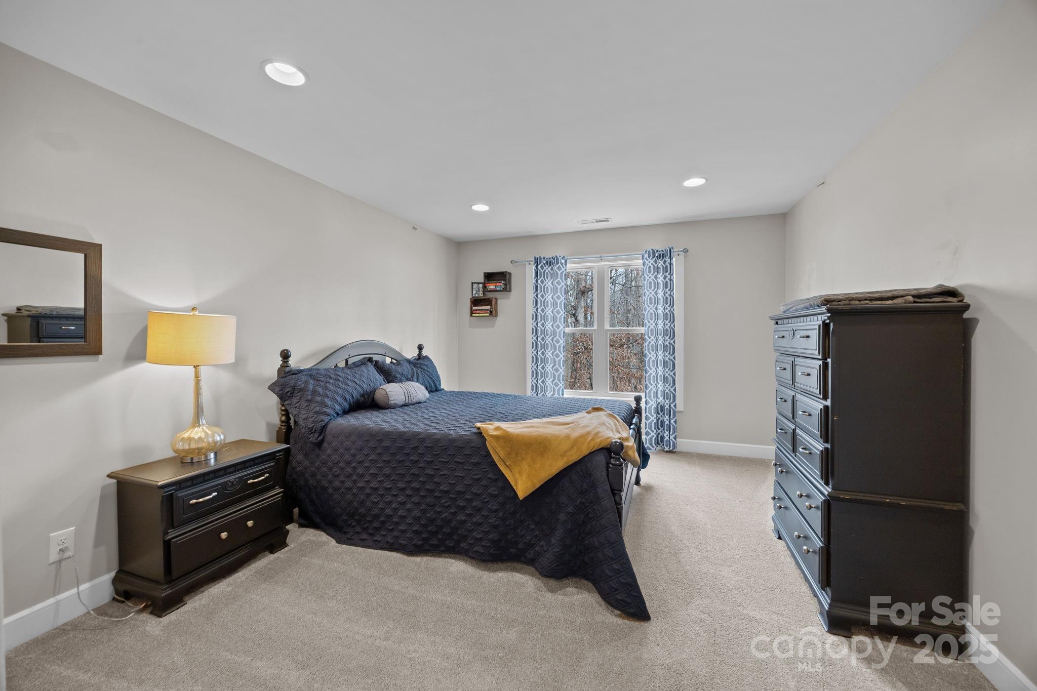 5321 Vesuvius Furnace Road Iron Station, NC 28080 - Photo 37 of 48 a spacious bedroom with a bed and wooden floor