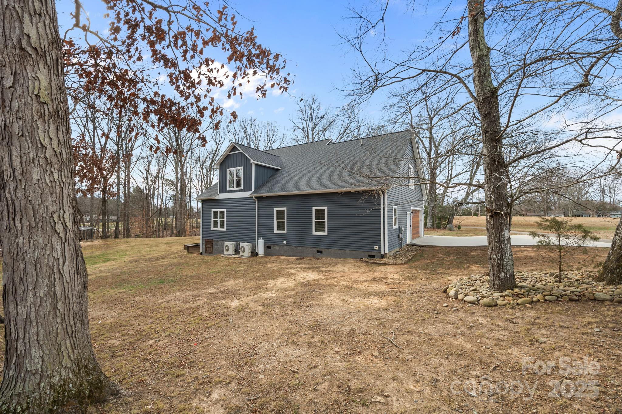 5321 Vesuvius Furnace Road Iron Station, NC 28080 - Photo 42 of 48 a front view of a house with a yard and trees
