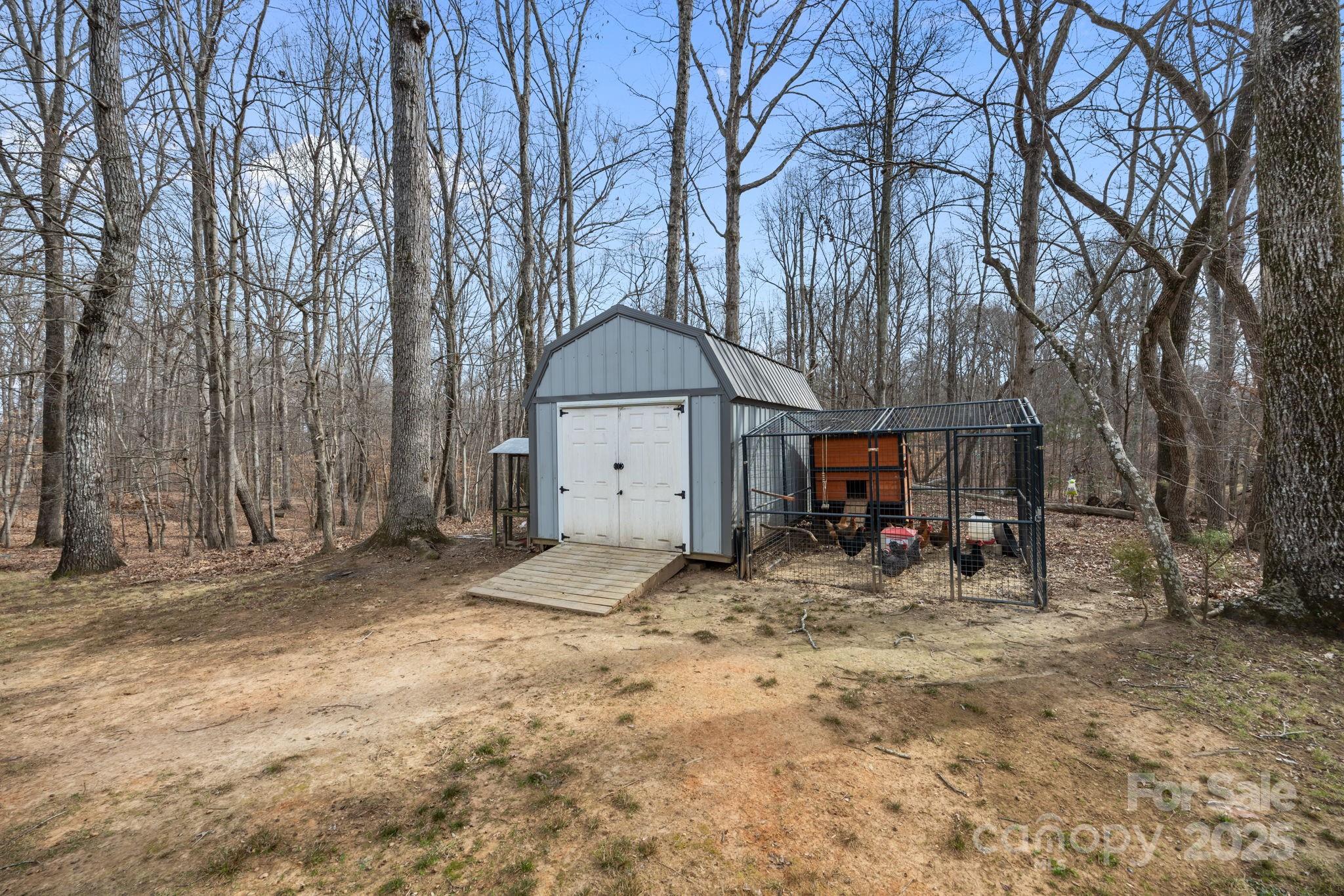 5321 Vesuvius Furnace Road Iron Station, NC 28080 - Photo 44 of 48 a view of a house with large trees and a car parked in front of it