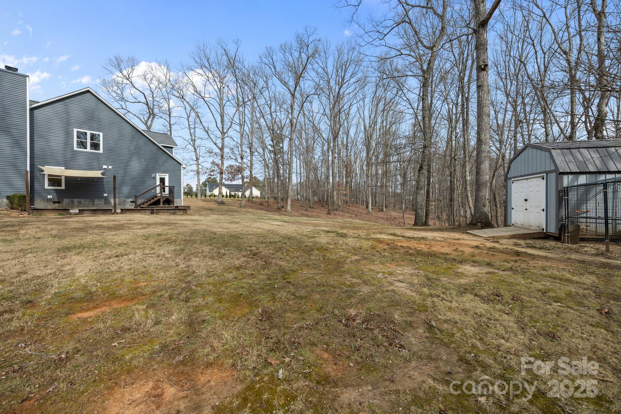 5321 Vesuvius Furnace Road Iron Station, NC 28080 - Photo 45 of 48 a backyard of a house with large trees and outdoor seating