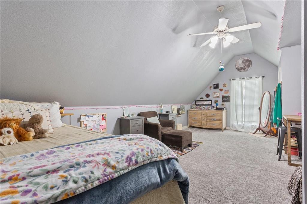 5616 Landsdown Drive Waco, TX 76708 - Photo 23 of 33 Carpeted room featuring a sloped ceiling and a ceiling fan with integrated lighting