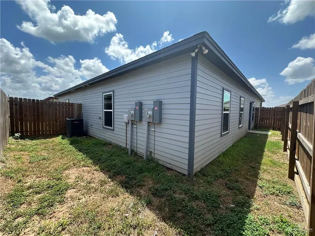 a front view of house with pathway and a yard