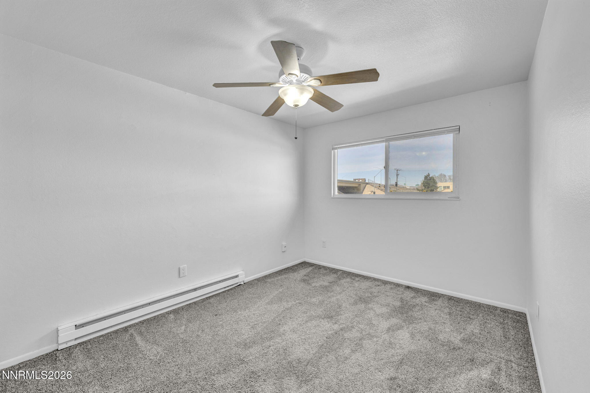 312 Smithridge Park Reno, NV 89502 - Photo 14 of 21 an empty room with a window and a fan