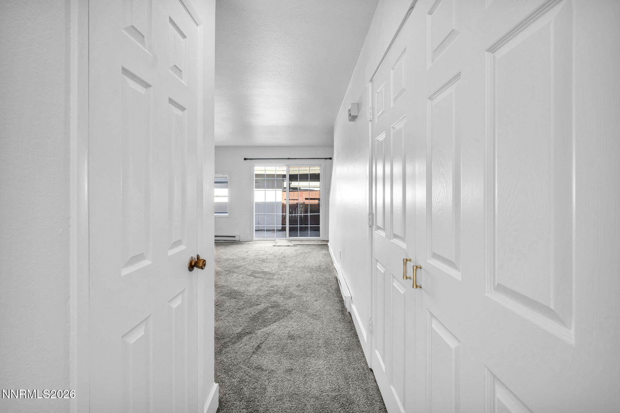 312 Smithridge Park Reno, NV 89502 - Photo 3 of 21 a view of a hallway with closet and wooden floor