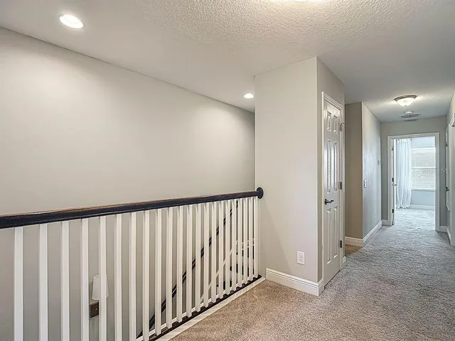 a bathroom with a granite countertop sink a toilet a mirror and shower