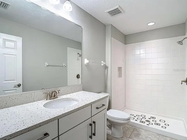 a view of a livingroom with a ceiling fan and window