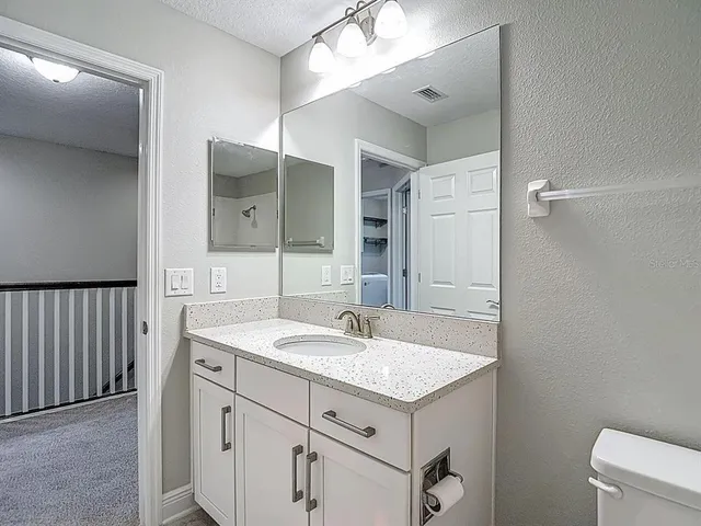 an empty room with a ceiling fan and window