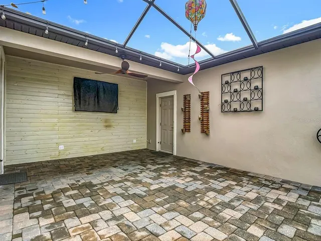 front view of house with a yard and potted plants