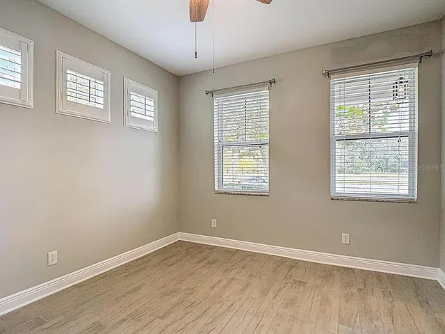a kitchen with stainless steel appliances granite countertop a sink a stove and a wooden floors