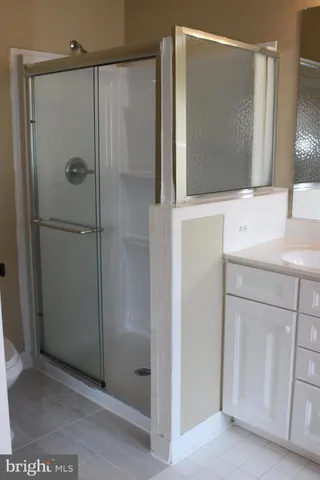 a bathroom with a shower sink and mirror