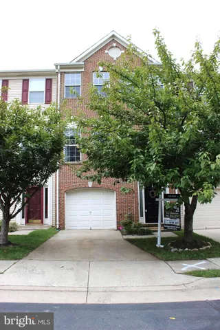a front view of a house with a yard and a garage