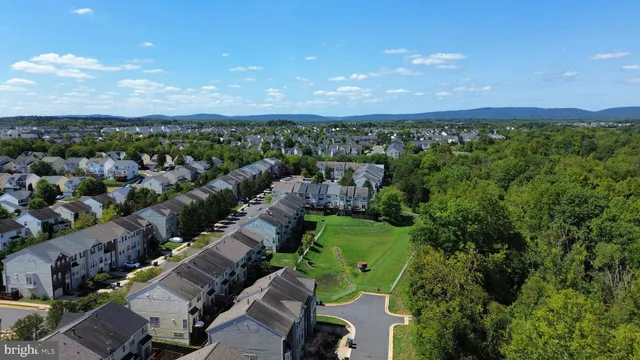 an aerial view of a houses with a yard