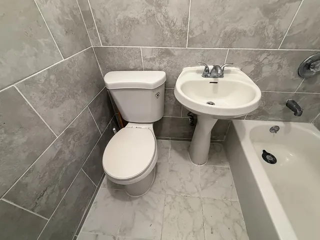 a bathroom with a sink toilet and a mirror