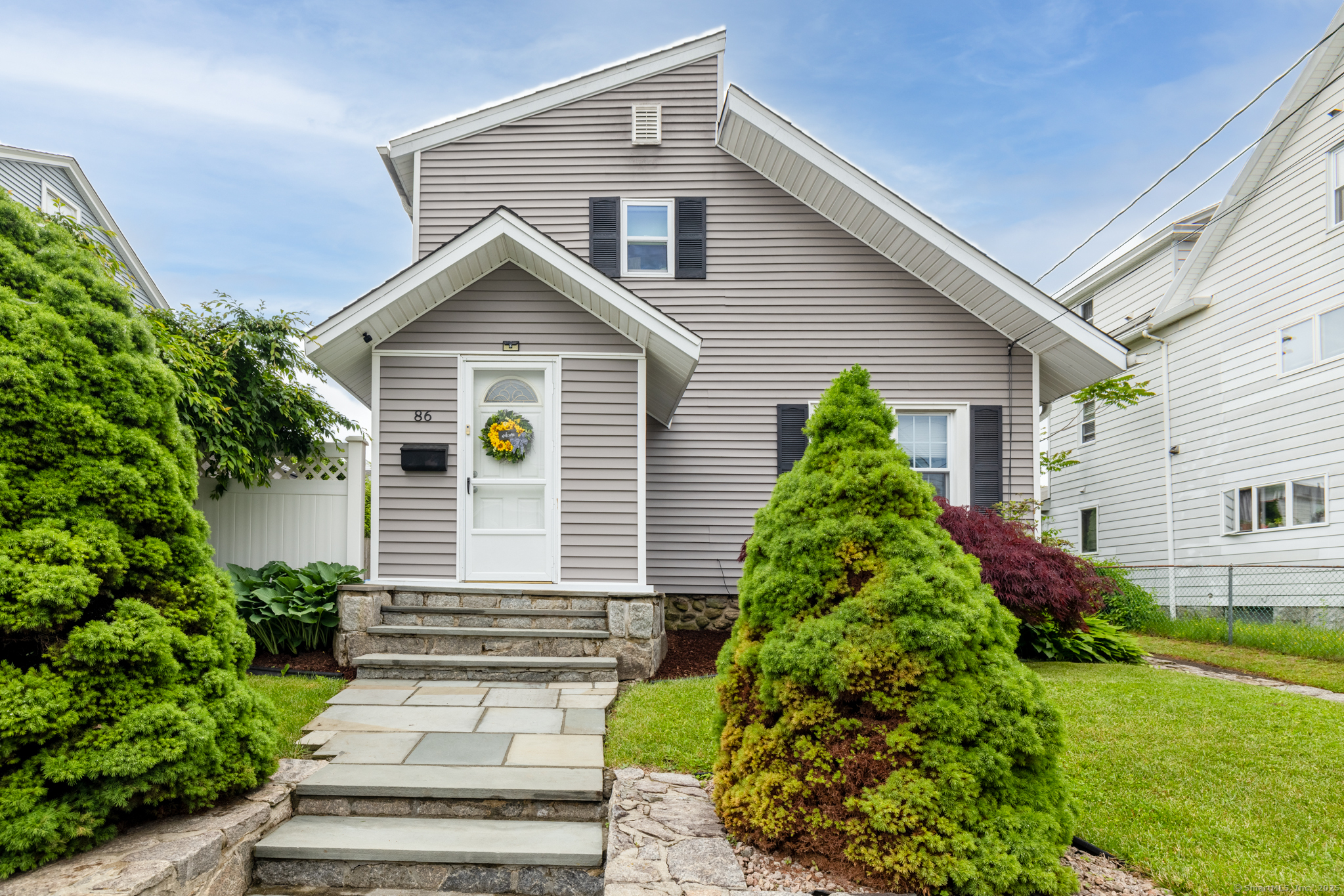 a view of a house with brick walls and potted plants