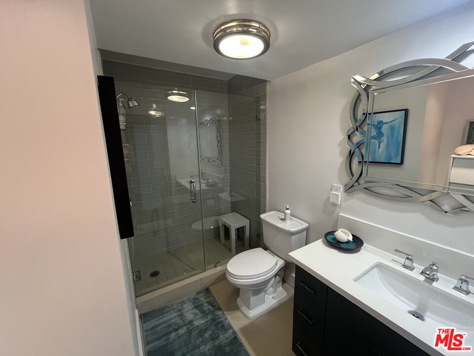 723 Palisades Beach Road, Unit 211 Santa Monica, CA 90402 - Photo 14 of 30 a bathroom with a sink a toilet a mirror and shower