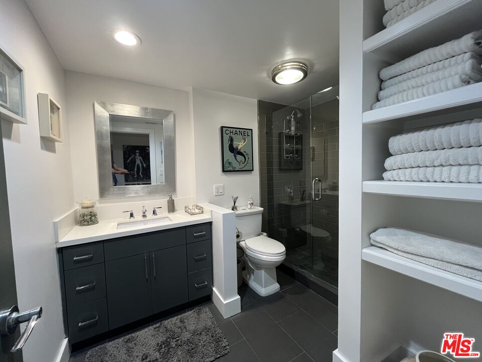723 Palisades Beach Road, Unit 211 Santa Monica, CA 90402 - Photo 21 of 30 a bathroom with a toilet sink double vanity and mirror