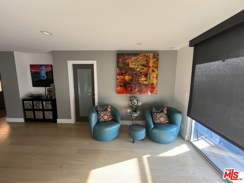 723 Palisades Beach Road, Unit 211 Santa Monica, CA 90402 - Photo 10 of 30 a living room with furniture and a flat screen tv