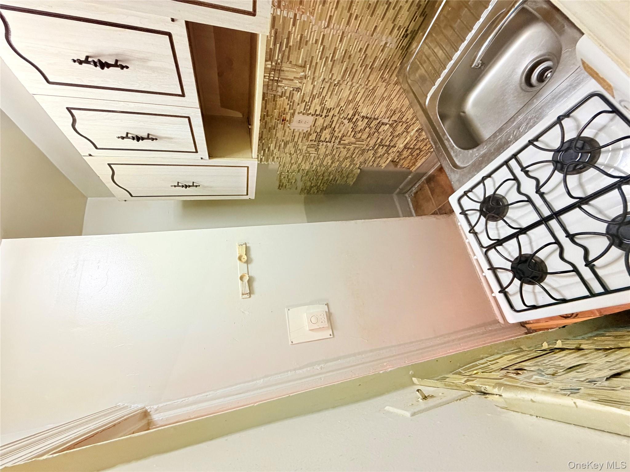 501 West 156th Street, Unit 22 Manhattan, NY 10032 - Photo 7 of 13 Kitchen with white cabinets and baseboards
