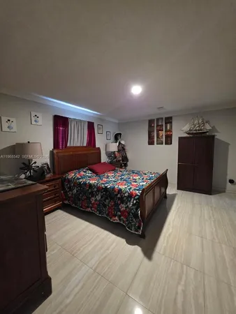 a bedroom with a large bed and a dresser