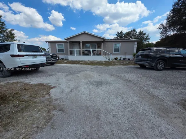 a view of a car park in front of house